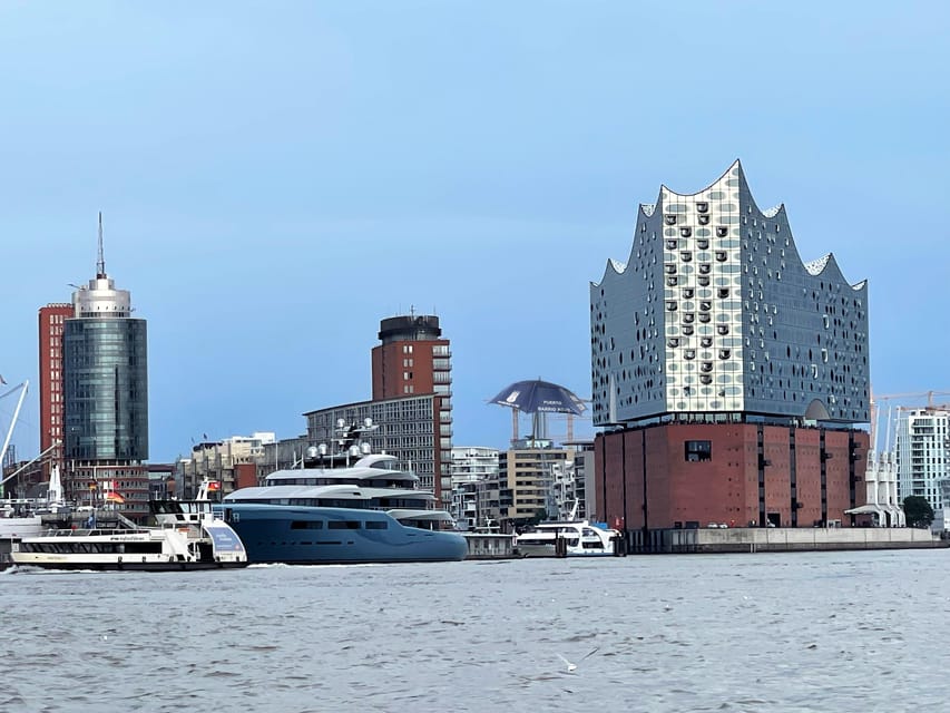 Free Tour: Port, Red Light District and Beatles. You decide how much to pay at the end - Where the tour starts: Landungsbrücken Brücke 5 and that blue umbrella